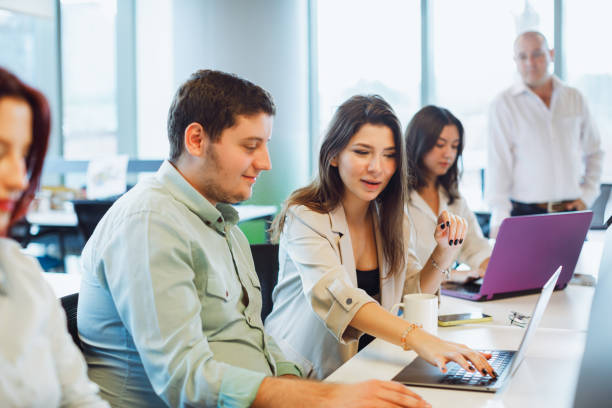 istock Dynamic Business Collaboration: Multiracial Business Team Engaged in a Productive Staff Meeting. Diverse Group  Planning Strategically, Brainstorming, Collaborating, and Working a Modern Office Setting 1915723856