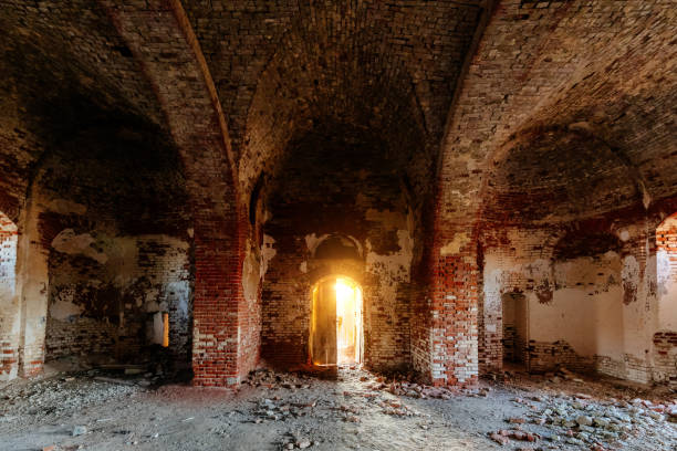 istock Dark corridor of old ancient abandoned red brick ruined historical building 1915725949