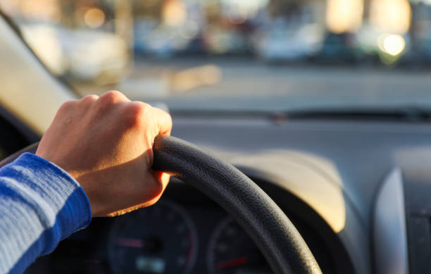 istock hand gripping a steering wheel while driving a car, focused and in control 1915743074