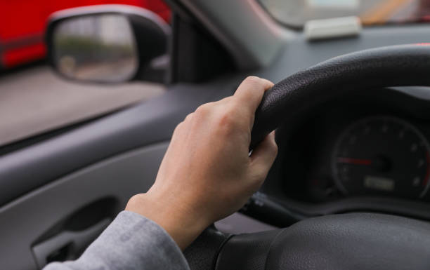 istock hand gripping a steering wheel while driving a car, focused and in control 1915743076