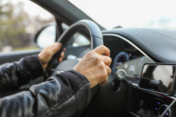 istock hand gripping a steering wheel while driving a car, focused and in control 1915743079