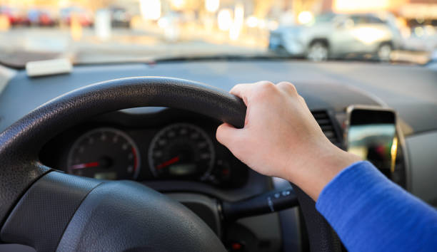 istock hand gripping a steering wheel while driving a car, focused and in control 1915743089