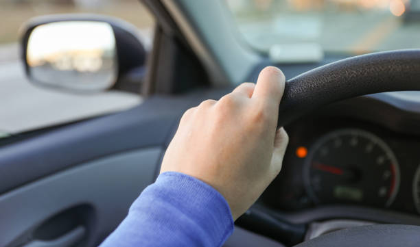 istock hand gripping a steering wheel while driving a car, focused and in control 1915743470
