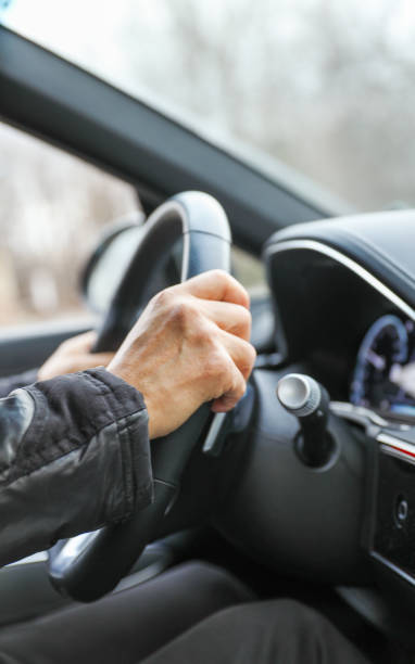 istock hand gripping a steering wheel while driving a car, focused and in control 1915743604