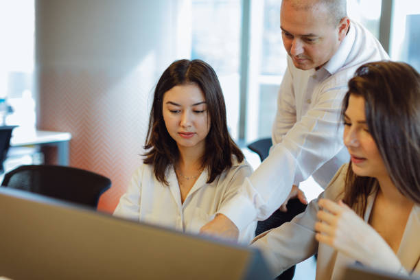 istock Dynamic Business Collaboration: Multiracial Business Team Engaged in a Productive Staff Meeting. Diverse Group  Planning Strategically, Brainstorming, Collaborating, and Working a Modern Office Setting 1915760540