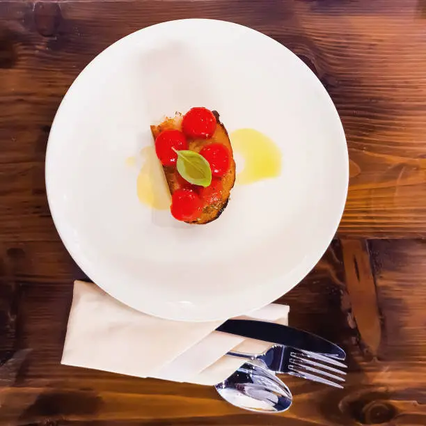 Photo of Italian Appetizer tomato on bread with fresh olive oil