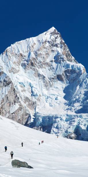 istock mount Nuptse and glacier with hikers 1915770432