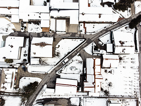Top down aerial view of a snow covered residential neighborhood