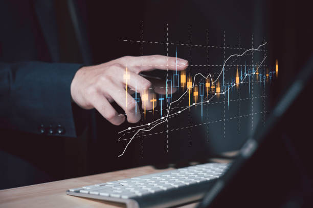 investment and finance concept, businessman holding virtual trading graph and blurred light on hand, stock market, profits and business growth. stock photo