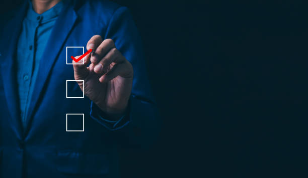 istock Checklist concept, business person checklist tick answer sign in checkbox, validation online questionnaire quality control document, man use pen to tick correct sign mark in checkbox form. 1915800600