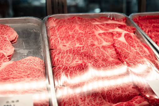 A close-up of the beautifully marbled Wagyu beef showcased in the storefront window.