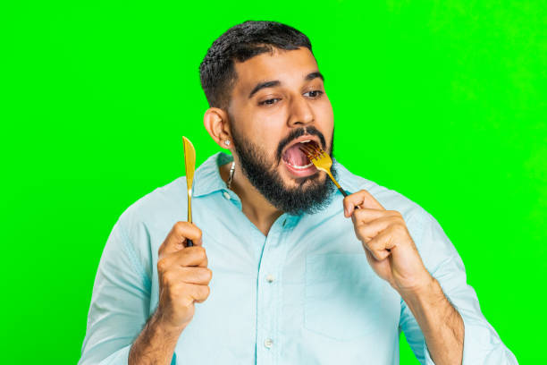 istock Hungry man waiting for serving dinner meal dishes with restlessness holding cutlery fork knife 1915835524