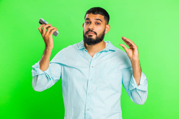 istock Disinterested tired Indian man having annoyed boring talk on smartphone online conversation, quarrel 1915835527