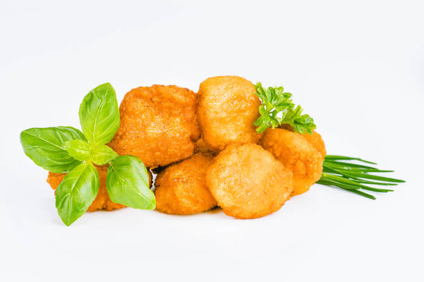 istock Breaded Chicken Inner Fillet on a White Background,Chicken Breaded Raw Meat.Chicken Breaded Fillet. Breaded chicken nuggets. Fast homemade food at home. Chicken breaded schnitzels. Fast cooking. 1915836041