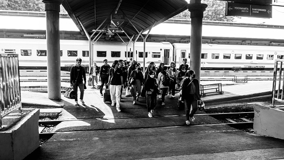 Surabaya, East Java, Indonesia - December 23, 2023 : The passenger had just arrived at Surabaya gubeng station and got off the train with a lot of luggage.