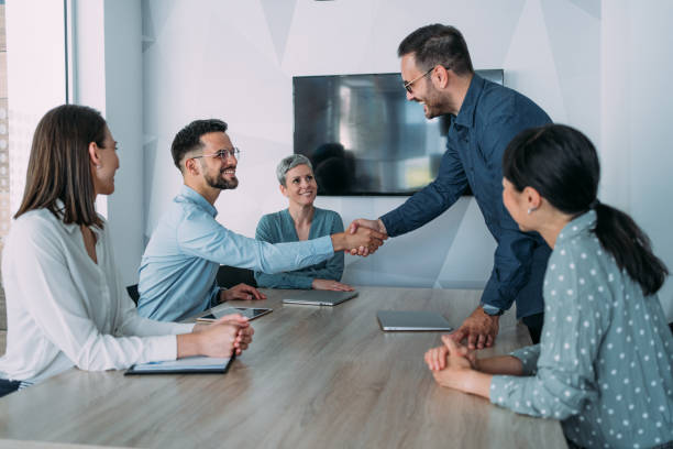 istock Businessmen shaking hands across the table. 1915928727