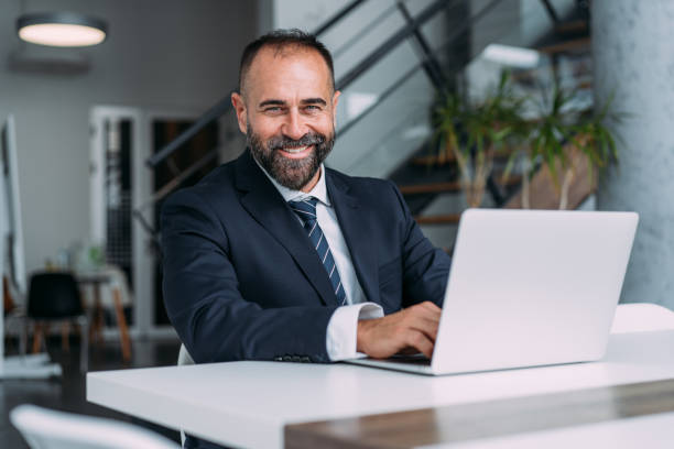 istock Successful businessman in modern office working on laptop. 1915928730
