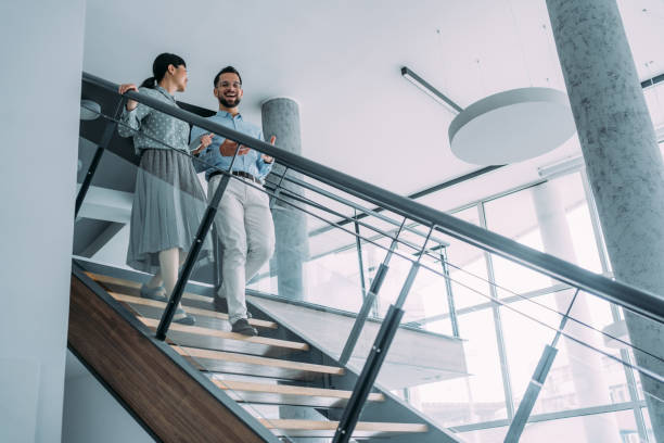 istock Business colleagues talking on stairs in the office. 1915928735