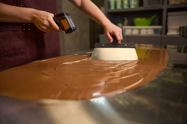 istock Experienced confectioner busy with tempering chocolate on kitchen countertop 1915933373