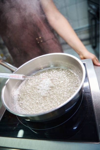 istock Experienced chef is measuring temperature of sugar syrup during cooking 1915933390