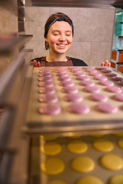 istock Smiling pastry chef preparing batch of cookies for baking 1915934501