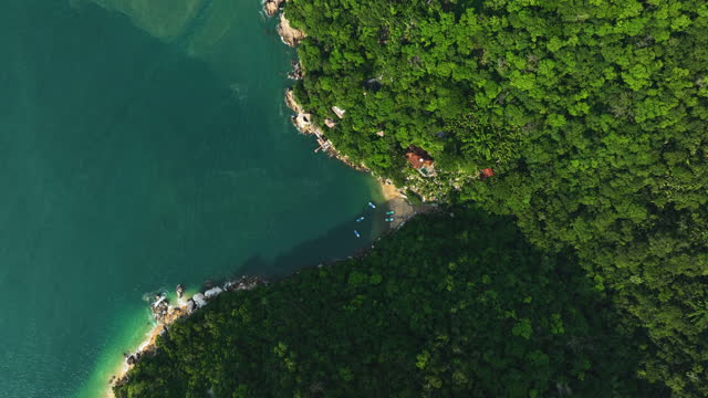 Aerial top down shot rising above boats at the Colomitos Beach, in sunny Mexico