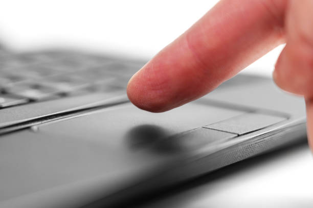 istock Using a laptop pressing the touchpad. Caucasian office manager hand finger and black network device button 1915941100