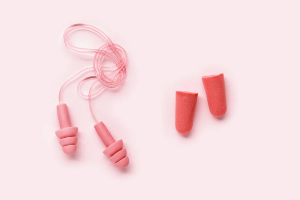 istock Set Colored earplugs as minimal momochrome layout, reusable silicone and rubber ear plug on cord against noise, protect hear, for swim, sleep, rest. Creative aesthetic flat lay, pastel tones, top view 1915956077