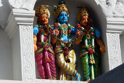 HYDERABAD,INDIA-SEPTEMBER 12,2017: View of Indian Hindu God Krishna with spouses radha and rukmimini statues on Temple tower