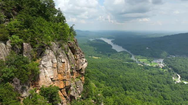 Aerial view of rocky mountain formation in Blue Ridge Mountains near Chimney Rock State Park. Geological features of cliff erosion