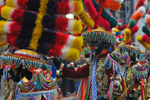Huanuco carnival with their traditional clothing Negritos with colored masks dancing in the streets of the city of Peru