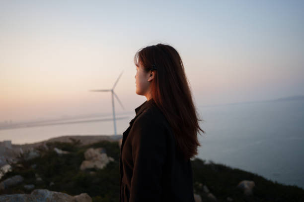 istock woman looking at the scenery at the seaside 1916024377