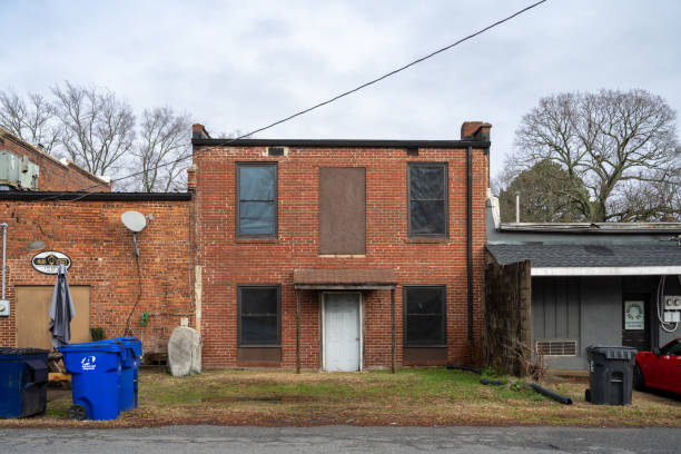 Huntersville, North Carolina, United States - 6 Jan 2024: Capture the mystery of Main Street Tavern, Huntersville. A rear shot of the historic brick building with a boarded-up door. Explore the town's forgotten charm.