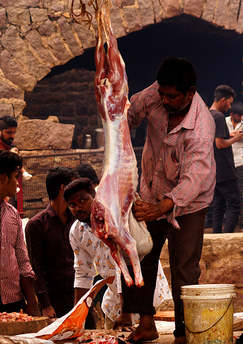HYDERABAD,INDIA-JULY 6,2019 : view of Indian butcher cutting goat ,during Bonalu Festival, for Hindu devotees to offer food to Goddess Mahankali