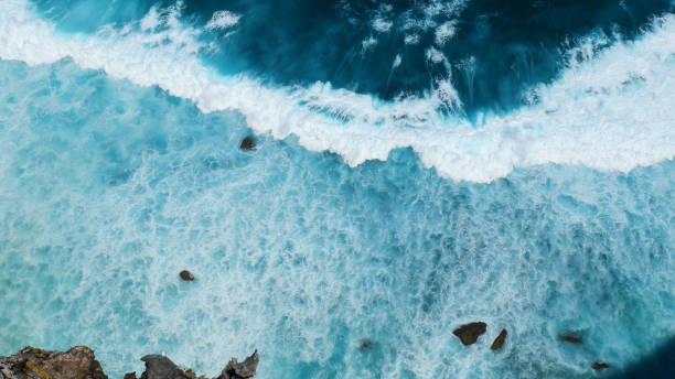 istock Turquoise ocean sea water white wave pattern splashing deep blue sea. Seascape dark ocean background wave splash on rock. Tropical sea beach in summer seaside outdoor. Water Surface blue wave pattern 1916047589