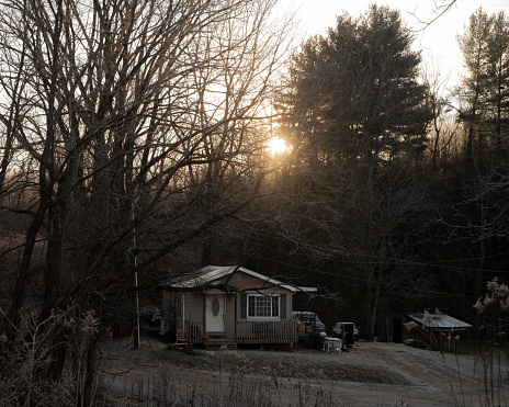 Asheville, North Carolina, United States - 5 Jan 2024:  Winter sunrise over a small home.