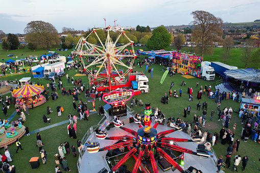 Lots of People are Enjoying Eid Day. A High Angle Drone's Point of View of a Funfair with Rides for Local Public of Luton City of England UK. The Funfair Was Held During Holidays to Celebrate Eid Festival of Muslim Community Who is Living at Luton Town of UK. The Funfair Was Held on April 21st, 2023