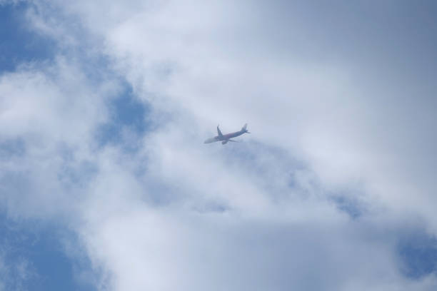 A Wizz Air Plane Flying in the Clouds and Sky at High Altitude after Take  off From London Luton Airport, England UK. Image Captured on April 8th, 2023 from City Centre of Luton Town of England.