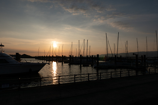 The orange of the sunset as the boats line the marina