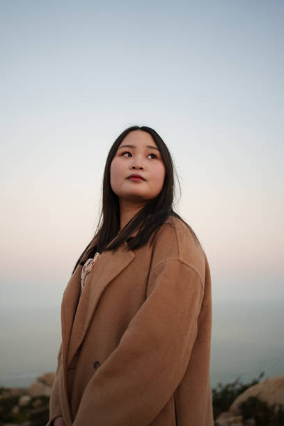 istock Young woman at dusk by the seaside 1916095162