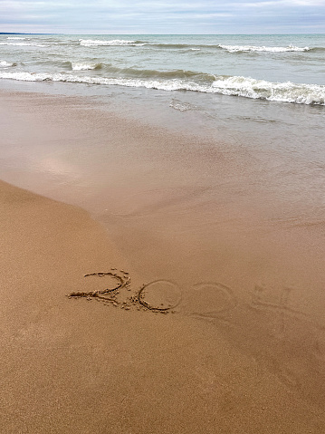 2024 written in the sand on a Lake Michigan beach