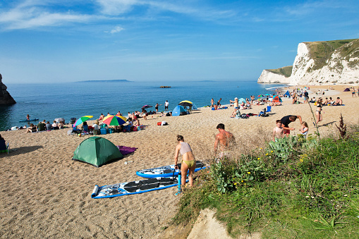 Too Many People are Enjoying at Durdle Door Beach Which is Most Popular Tourist Attraction of England United Kingdom. It Was The Most Hot day and sunny Day of Year 2023 with Temperature Above 40 Degree Celsius at This Tourist Place. Image Captured on September 9th, 2023