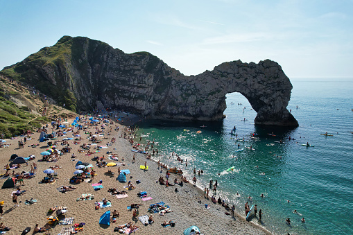 Too Many People are Enjoying at Durdle Door Beach Which is Most Popular Tourist Attraction of England United Kingdom. It Was The Most Hot day and sunny Day of Year 2023 with Temperature Above 40 Degree Celsius at This Tourist Place. Image Captured on September 9th, 2023