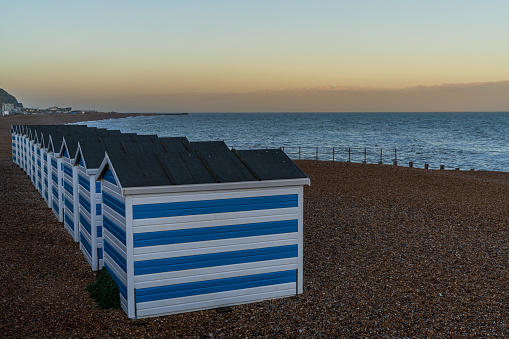 Hastings, East Sussex, England, UK - May 11, 2022: Evening mood on the beach with some beach huts