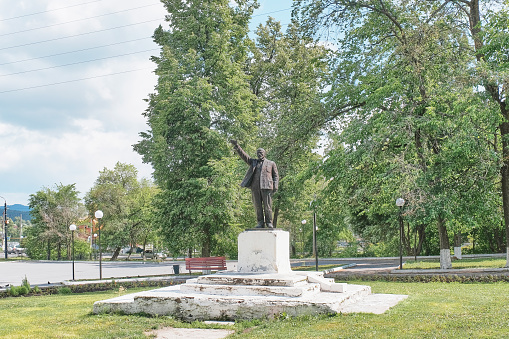 Zlatoust, Russia - June 20, 2023: Historical monument to Lenin in city garden. Soviet statesman and politician, Marxist theorist, founder of Communist Party and Soviet state in Russia. Cityscape