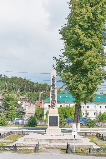 Zlatoust, Russia - June 20, 2023: Monument-obelisk with star on mass grave of participants of Bolshevik underground, shot in 1918-19. Summer cityscape. Travel concept