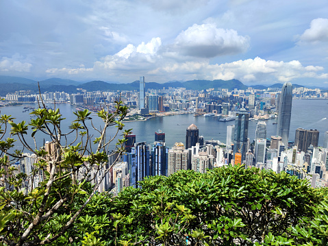Hong Kong, August 2018. Top View of Hong Kong City Skyscrapers and Victoria Harbour from The Peak.