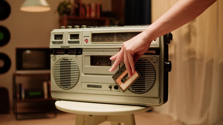 Retro radio tape recorder close-up. Listening to music, old radio boombox player, searching channel.