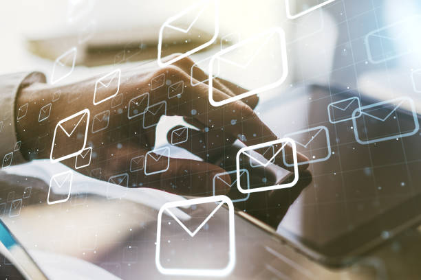 istock Double exposure of postal envelopes hologram with finger clicks on a digital tablet on background. Electronic mail and spam concept 1916315392
