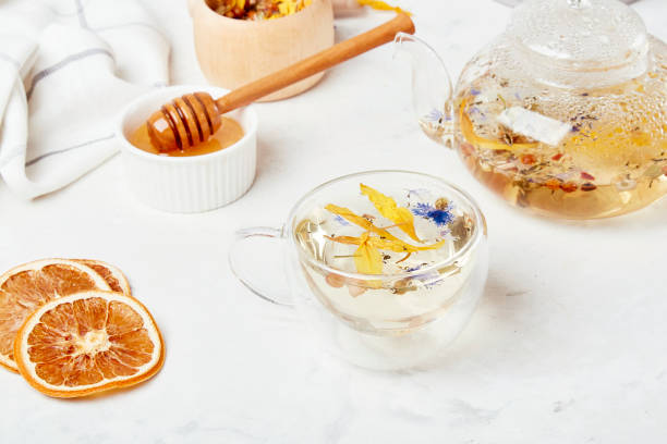 istock Alpine wellness elixir, natural tea in glass cup. Organic mountain blend - refreshing herbal infusion concept 1916363840